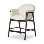 Side angle showing full armrest curve with dark wood and soft fabric contrast