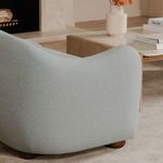 Close-up rear corner of Bria sofa showing fabric texture and smooth curve of armrest