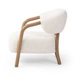 Pair of Brodie Chairs in room setting with warm brown walls and textured rug floor