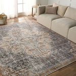 Lynette rug placed in living room setting beside beige sofa and wooden side table on hardwood floor