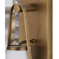 Close-up side view showing curved metal handle and knob detail in antique brass finish