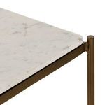 Side angle focusing on lower two marble shelves and slender iron vertical supports