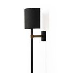 Angled side view of Maurice Sconce showing black backplate and on/off switch on brass arm