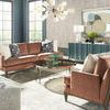 Calliope Cocktail Table in a bright living room with velvet sofas, decorative pillows, and contemporary lighting