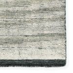 Detailed view of Farrow rug edge highlighting the woven texture and variegated gray and ivory fibers