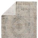 Rug corner flipped to show white fabric backing with grid knit structure