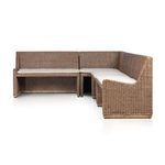 Side angled view of rattan banquette emphasizing smooth curves and cushioned seating