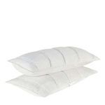 Two cloud white shams stacked showing thickness and large quilted channel texture