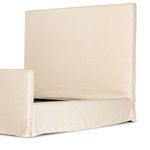 Front-facing queen bed in natural linen slipcover with two pillows and white bedding