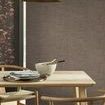 Rustic Weft Wallpaper applied on wall behind dining table with wood chairs and brass pendant light