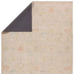 Back view revealing the rug’s dark backing with outlines of the faded floral pattern visible from front