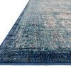 Side angle highlighting rug’s flat weave texture with rich blue border and intricate pattern details