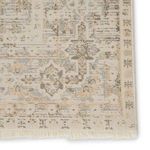 Close corner with fringed edges, highlighting vintage brocade pattern and lightly distressed finish
