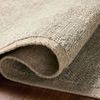 Close-up of folded rug highlighting thickness and texture of wool fibers