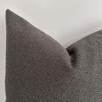 Close-up angled view focusing on rich textured weave and soft fabric of graphite pillow cover
