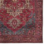 Close-up of the rug's corner focusing on medallion details and slightly frayed edges