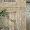 Close-up of flaky white wood grain and texture on Ciao Bella table corner with rosemary sprig