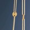 Close-up of gold suspension chain links with flat circular decorative discs on Verbank pendant