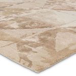 Close-up angled view showing the rug’s plush high-low pile texture and color blending of taupe and cream