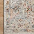 Close-up of rug corner on hardwood floor highlighting detailed border pattern