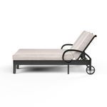 Side view showing adjustable backrest angled upright and decorative wheels on the Monterey Double Chaise