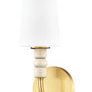 Casey wall sconce from slightly angled front highlighting brass back plate and white shade