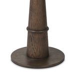 Close-up of brown oak tapered base with visible wood grain and round base platform