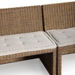 Close-up detail of rattan weaves forming the sturdy base supports beneath cushions