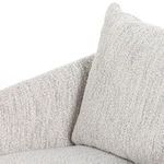 Close-up focusing on back pillow texture and right armrest contour