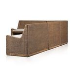 Textured beige cushion fabric with single tufted button detail up-close