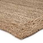 Side angle view highlighting the rug’s thickness and layered woven border texture