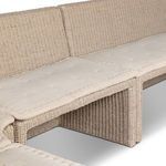Close-up detail of fabric seat cushions with subtle tufting on the outdoor banquette