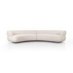 Large curved sectional sofa in light beige high-performance fabric with smooth continuous back and wide rounded armrests