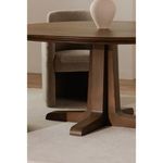 Charles dining table styled in dining room setting with upholstered chair and vase on table.