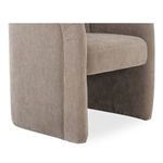 Close-up of front left corner displaying beige upholstery texture and base over rolling casters