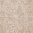 Top-down view showing full faded pattern of beige and blue traditional motifs on rug