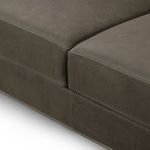 Close-up detailing the sofa’s lower upholstery and leather seam near the base