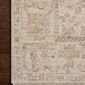 Close detail of Milena rug corner on dark hardwood floor showing intricate beige and grey pattern