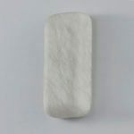 Unlit alabaster sconce against a light gray wall showing matte surface details
