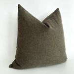 Liman Espresso pillow shown at a three-quarter angle highlighting fabric texture and shape