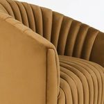 Close-up on armrest and channel tufting texture of bronze velvet swivel chair