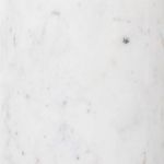 Close-up of white marble base showing natural veining and polished texture
