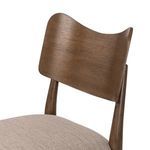 Close-up detail of the curved wooden backrest showing smooth wood grain and finish