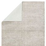 Rug corner flipped over to reveal light-colored non-slip backing