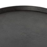 Close-up showing textured edge of round iron tray top