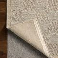 Alina Dove rug corner lifted to reveal wool backing and layered underside against hardwood flooring