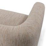 Close-up of rounded arm and backrest seam with detailed beige and brown woven fabric