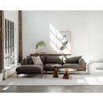 Wide living room shot with sectional sofa, two wood tables, abstract art, and natural daylight