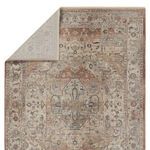 Rug with top left corner flipped to reveal light underside and backing material