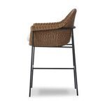 Side profile showing basket-weave texture of frame and cushion depth supported by iron base